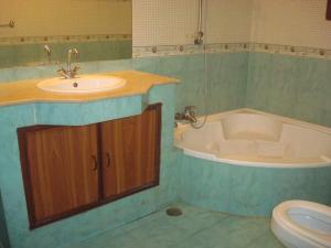 a bathroom with a sink and a tub and a toilet at Seaview Guest House in Karachi +31 photos