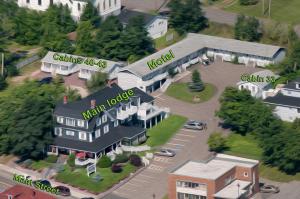 a model of a house with a building and cars at Telegraph House Motel in Baddeck