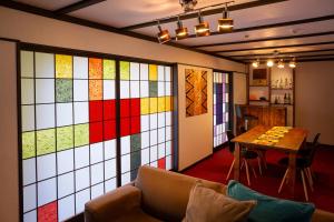 a room with a wall of stained glass windows at Taisho Modern Villa Zen in Hakone