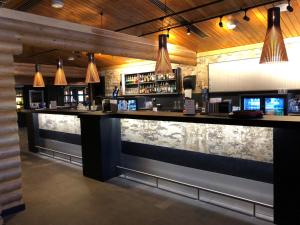 a bar in a restaurant with a stone wall at Levi Hotel Spa in Levi