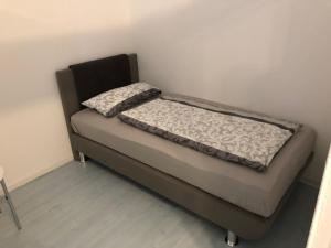 a small bed in a room with a bed frame at Ferienwohnungen Gassmann in Schutterzell