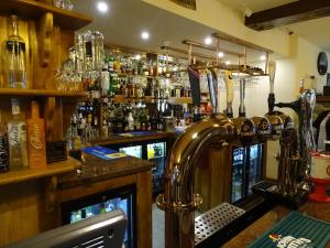 a bar with a bar counter with alcohol bottles at Ellesmere Hotel in Ellesmere
