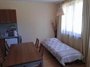 a small room with a table and a bed in it at Borovets Apartment, Villa Park in Borovets