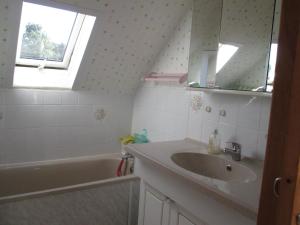 a bathroom with a sink and a bath tub at 3 Rue Vicaire in Contalmaison