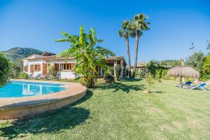 a house with a yard with a swimming pool at Can Blanco - Nordvillas in Pollença
