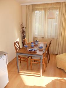 a dining table and chairs in a living room at Borovets Apartment, Villa Park in Borovets