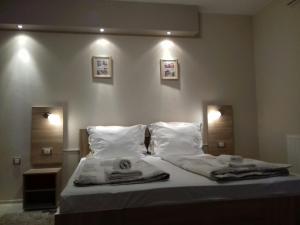 a bedroom with a bed with two towels on it at Guest House Dimitrije in Niška Banja