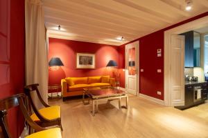 a living room with a yellow couch and red walls at Villoresi Mansion in Florence