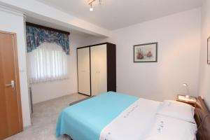 Ένα ή περισσότερα κρεβάτια σε δωμάτιο στο Apartments Daria