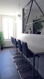 a row of chairs around a table in a room at Hôtel de Clèves in Nevers