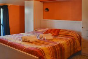 a bedroom with a bed with two pillows on it at Hotel Urbinati in Bellaria-Igea Marina