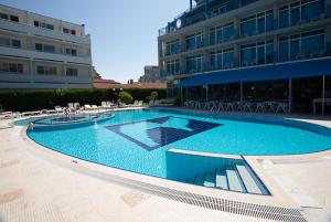 a large swimming pool in front of a building at Regata Palace Hotel in Sunny Beach