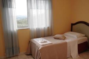 a small bed in a room with a window at Oasis of CalmnessΕ in Ardánion