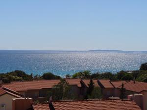 a group of houses with the ocean in the background at Pansion Comfort Sidro in Novalja