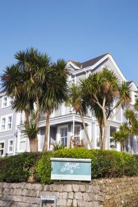 a white house with palm trees in front of it at The Lerryn in Falmouth