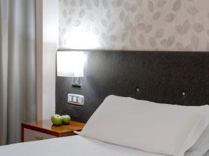 Postel nebo postele na pokoji v ubytování Hotel Plaza Las Matas
