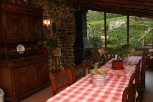 a dining room with a table with plants on it at Casa Rural Pikatzaenea in Sopuerta