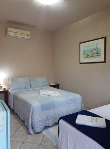 Ένα ή περισσότερα κρεβάτια σε δωμάτιο στο Pousada dos Navegantes