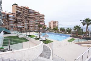 a view of the pool at a resort with buildings at Apartamento Postman in Arenales del Sol
