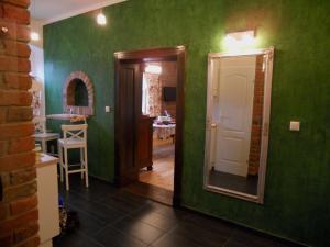 a green room with a mirror and a hallway at Apartament Katowice - Nikiszowiec in Katowice