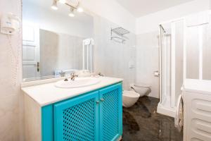 a bathroom with a blue sink and a toilet at AT Almoraide Rooms Suites in Nerja