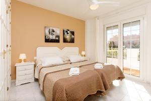 a bedroom with a large bed and a window at AT Almoraide Rooms Suites in Nerja