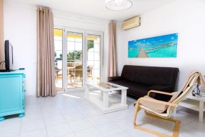 a living room with a couch and a table at AT Almoraide Rooms Suites in Nerja