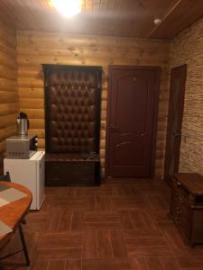 a room with wooden walls and a door and a refrigerator at Diva Mini-hotel in Podolsk