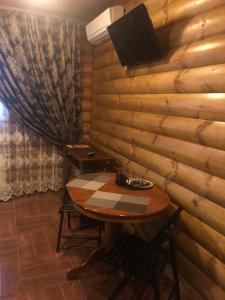a table in a room with a wooden wall at Diva Mini-hotel in Podolsk