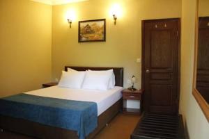 מיטה או מיטות בחדר ב-Utopia Lodge Hotel