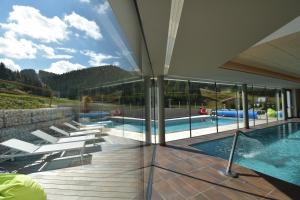 a view of a swimming pool from a house at Hotel La Baita in Folgaria