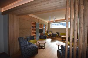 a living room with a couch and chairs and a table at Hotel La Baita in Folgaria