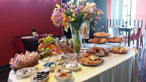 a table with a bunch of food and flowers at B&B La Suite Alba Adriatica in Alba Adriatica