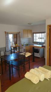 a kitchen and dining room with a table and chairs at cabañas sector peñuelas in Coquimbo