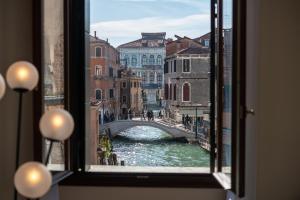 a view through a window of a city street at Palazzo Vendramin Costa in Venice