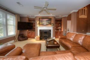 a living room with a couch and a fireplace at The Village Condo in Greensboro