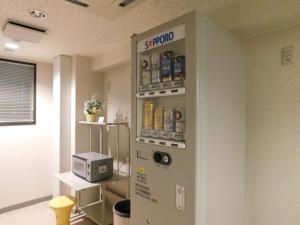 a vending machine in a room with a microwave at Hotel Crown Hills Kitami in Kitami