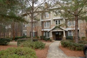 a large brick house with a driveway in front of it at The Village Condo in Greensboro
