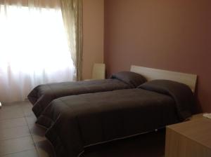 2 Betten in einem Zimmer mit Fenster in der Unterkunft A casa di Armando in Rom