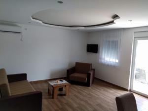 a living room with a couch and a chair at Simića ćoše in Vrdnik