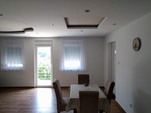 a dining room with a table and chairs and a window at Simića ćoše in Vrdnik