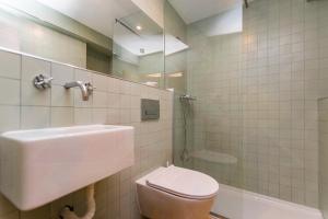 a bathroom with a sink and a toilet and a shower at Alfama Historical Apartment in Lisbon