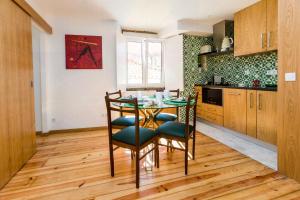 a kitchen with a glass table and chairs at Alfama Historical Apartment in Lisbon +11 photos