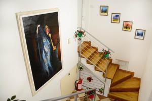 a staircase with a painting on the wall and christmas decorations at Apartmani Janjic in Banja Luka +170 photos