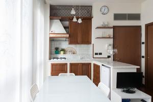 a kitchen with a white table and a television at Studio Downtown Fantastic Area in Milan