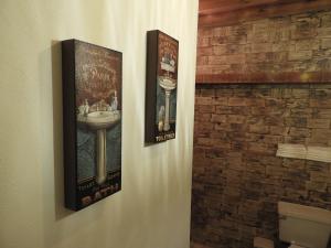 two posters on the wall of a bathroom with a sink at Casa del Temezcuitate in Guanajuato +87 photos