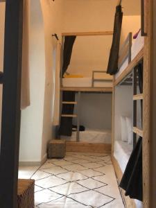 a room with bunk beds and a tiled floor at BED SQUARE Hostel in Marrakesh