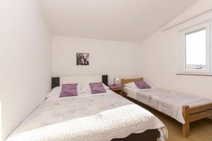 Postel nebo postele na pokoji v ubytování Apartment Nediljka