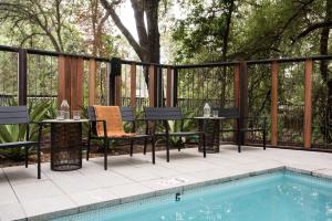 a patio with a table and chairs next to a swimming pool at Harmon Guest House in Healdsburg