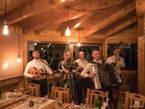 a group of people standing in a room with an accordion at Bergkranc Hotel & Resort in Pale